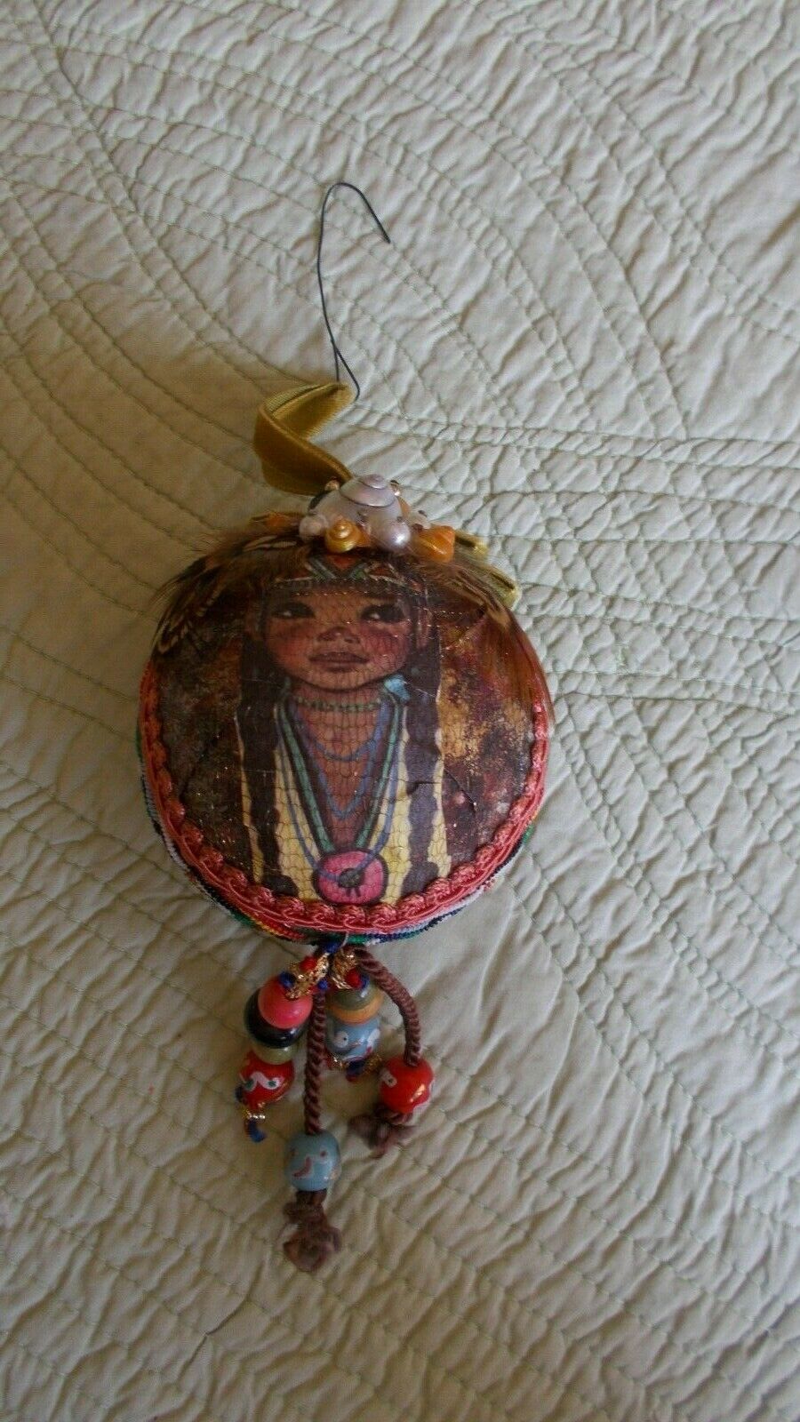 Hand made beaded, braided, feathered Native American ornament with boy & girl